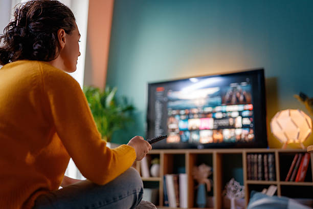 istock woman watching TV 2260663619