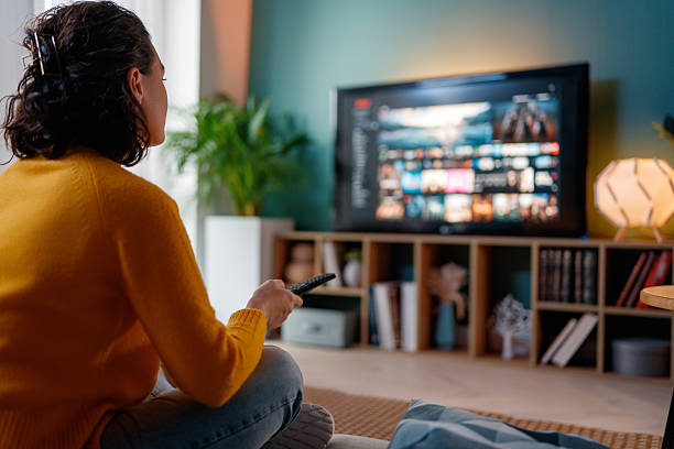 istock woman watching TV 2260663637