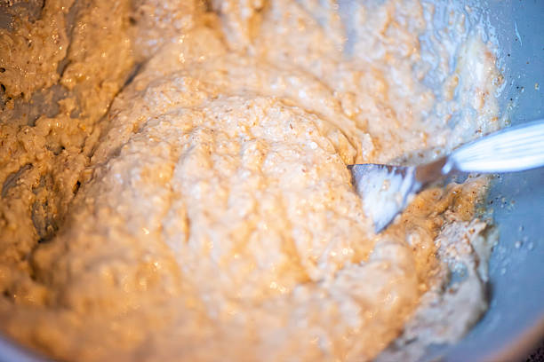 A simple baking moment capturing egg, yogurt, and oat flour being mixed together, emphasizing homemade preparation and wholesome ingredients.