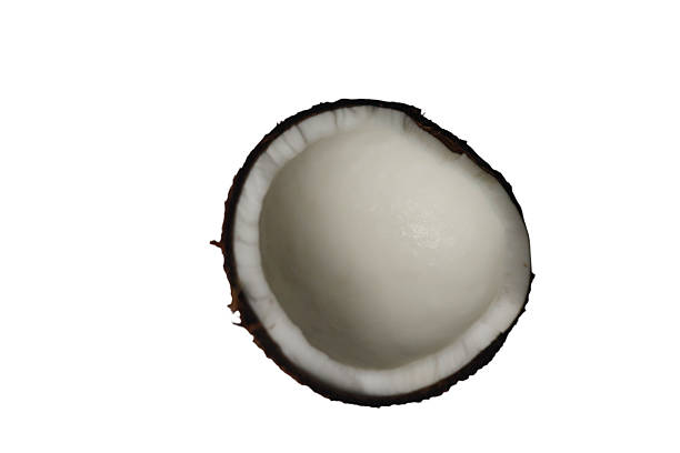 A halved coconut with a brown shell and white interior is shown isolated on white background