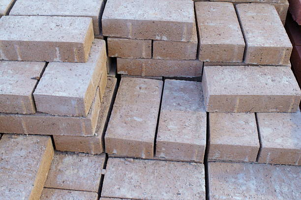 Stacks of new red bricks for sale at a home improvement store.