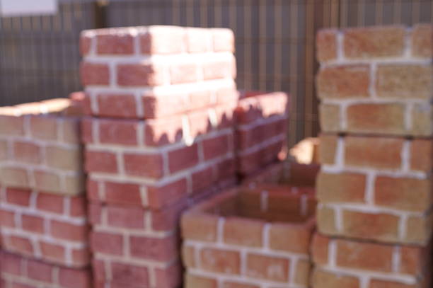 Stacks of new red bricks for sale at a home improvement store.