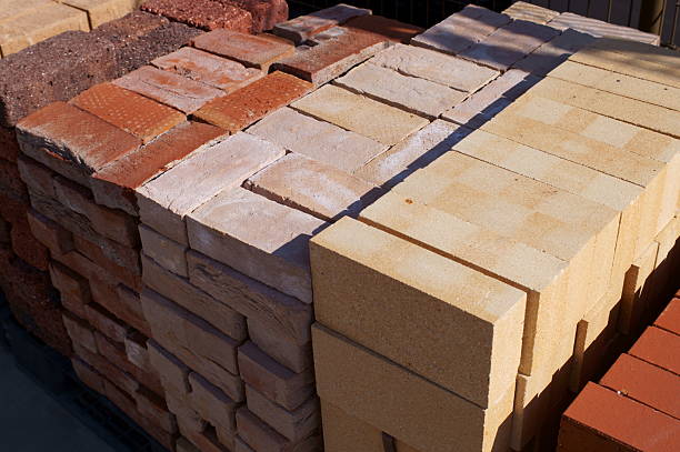 Stacks of new red bricks for sale at a home improvement store.