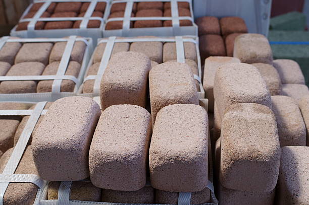Stacks of new red bricks for sale at a home improvement store.