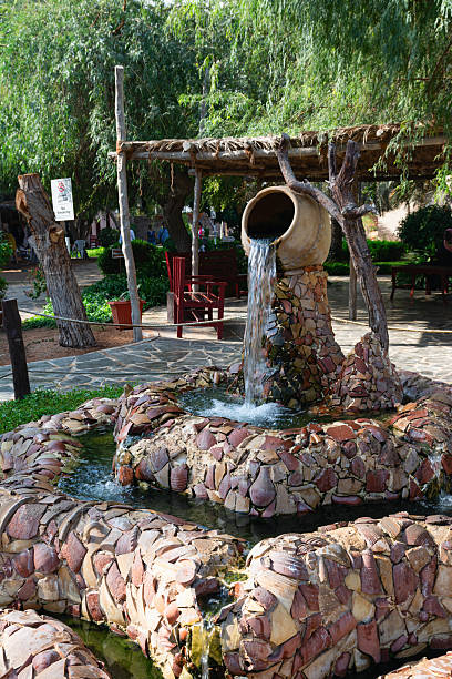 Abu Dhabi, United Arab Emirates  - December 5, 2016:  Decorative water fountain at Emirates Heritage Village Abu Dhabi, UAE