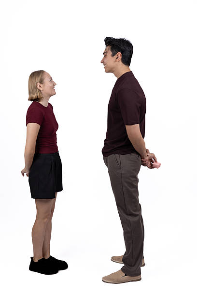 Man and woman standing opposite each other in studio