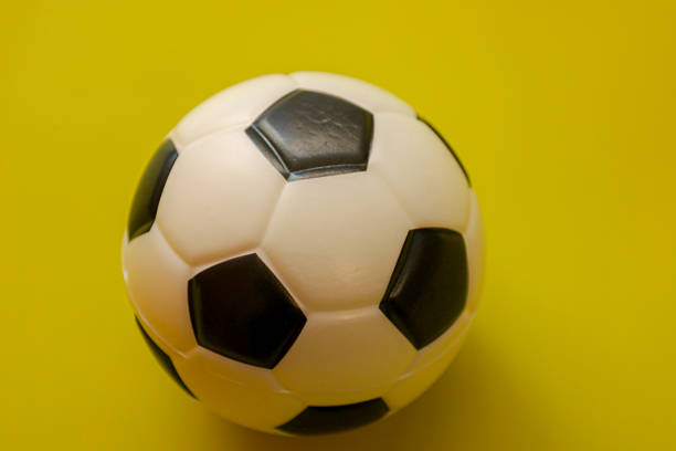 Wooden mannequin with a soccer ball