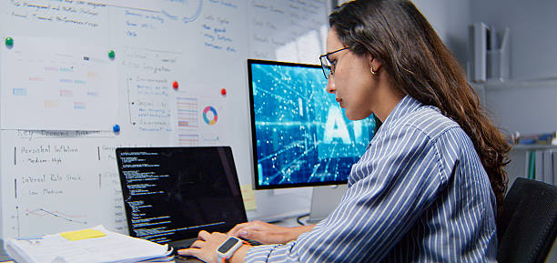 White Latin female software engineer developer, coding AI program on laptop computer at home office at night. Internet information technology. programmer freelance job, artificial intelligence at work stock photo