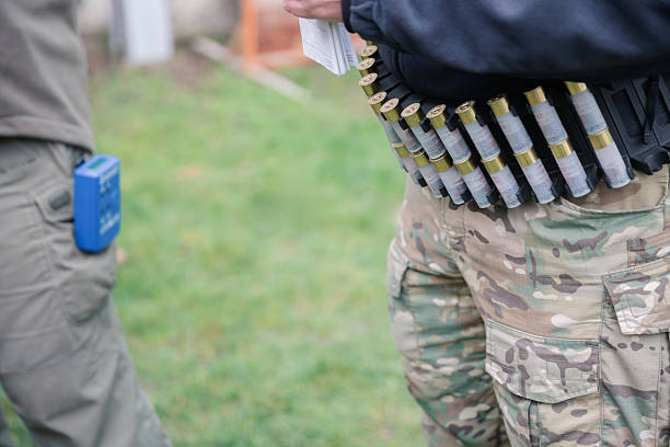 Shooter wearing tactical camouflage pants with a shotgun shell ammo belt