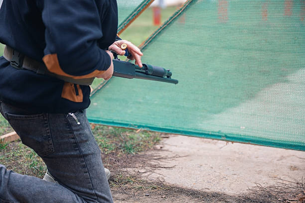 Person reloading a shotgun during a shooting sport training session