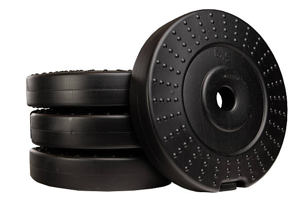 Black plastic weight plates. Plastic weight plates isolated on a white background
