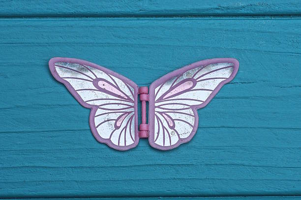 One plastic white pink butterfly toy lies on a blue table