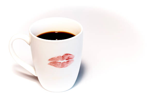 Young couple sharing a tender moment while having coffee on their balcony