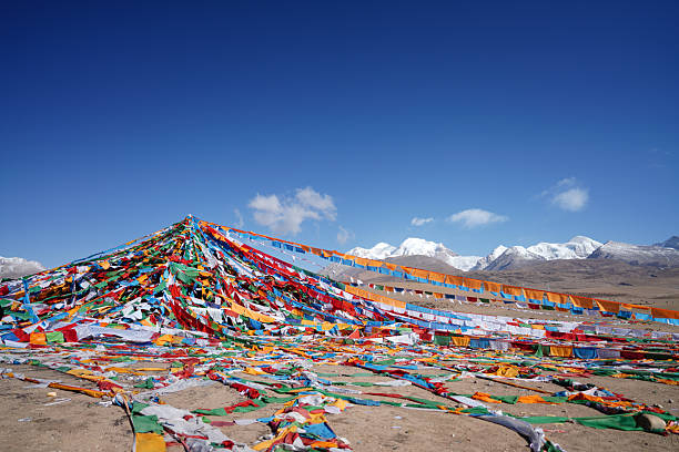 Prayer Flags​ are colorful rectangular cloths, often printed with sacred Buddhist texts, mantras, and images. They are a central feature of Tibetan Buddhist culture, used to bless the surrounding space. The five colors (blue, white, red, green, yellow) represent the five elements. It is believed that the wind carries the prayers and blessings printed on them across the land, spreading peace and compassion. They are commonly seen strung across mountain passes, temples, and villages in the Himalayas.