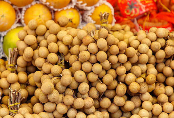 Ripe longan fruits as background. Texture.