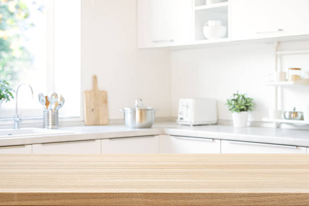 istock Wooden table top for product promotion over defocused modern kitchen counter background 2260833250