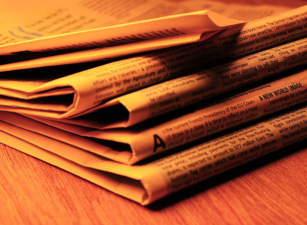 Pile of newspapers stacks on table
