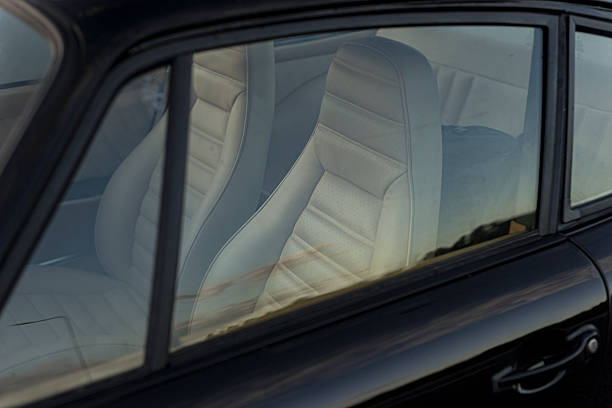 Leather rear seats of a vintage classic car mid-20th century automotive craftsmanship, with textured surfaces, comfort and retro aesthetics.