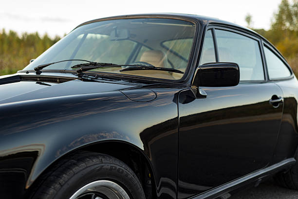 Vilnius, Lithuania - October 7, 2025: Upper part view including front windshield and drivers side door of a black Porsche 911.