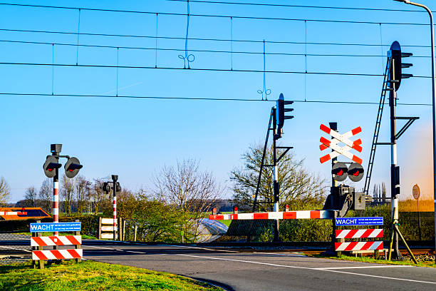Road signs at the railway crossing with traffic light, isolated on white background. Railroad warning with flashing red light