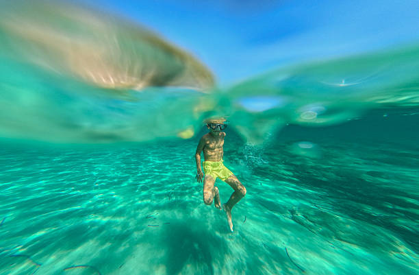 Photo of a young boy free diving in the sea