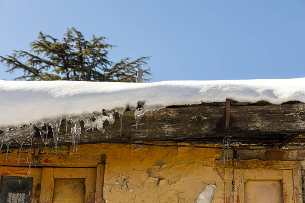 icicles dripping from frozen rooftop during cold winter day