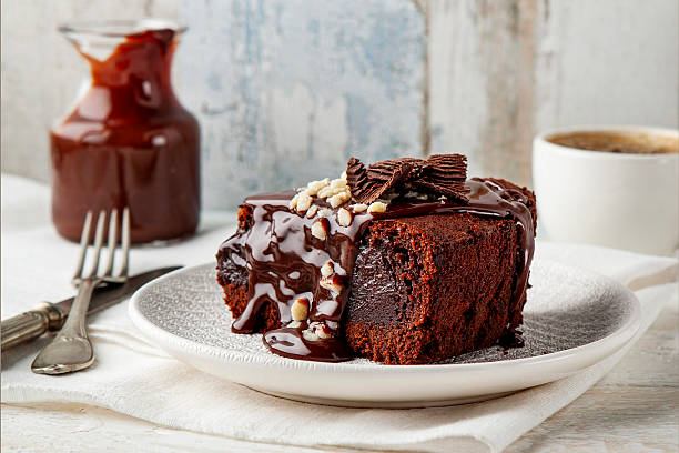 Raw chocolate cake with dark chocolate pieces, homemade traditional brownie from an old recipe, real brownie