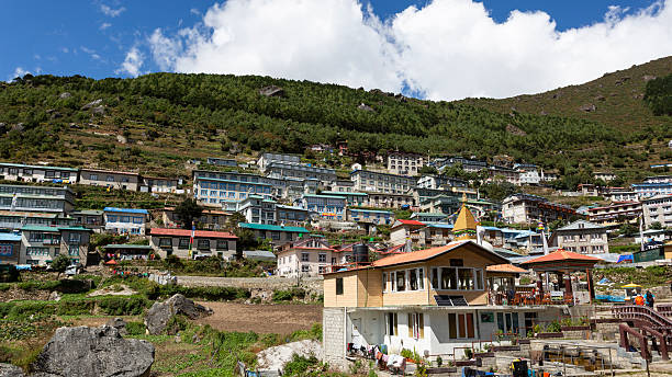 Namche Bazaar, Nepal - October 9, 2025: Trekkers enter the village of Namche Bazaar through a gate.
