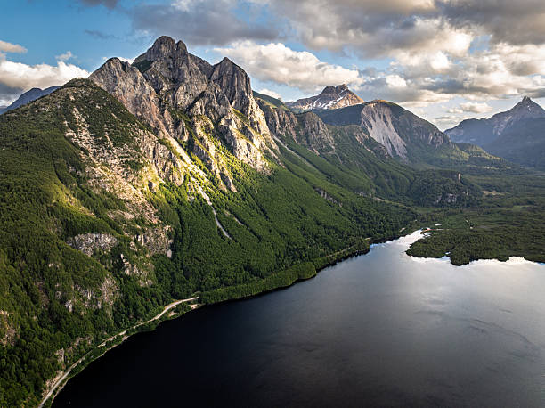 Rocky mountain cliffs rising above Lago Las Torres in southern Chile. Scenic Patagonian landscape captured along the Carretera Austral featuring forest, lake and mountain scenery.