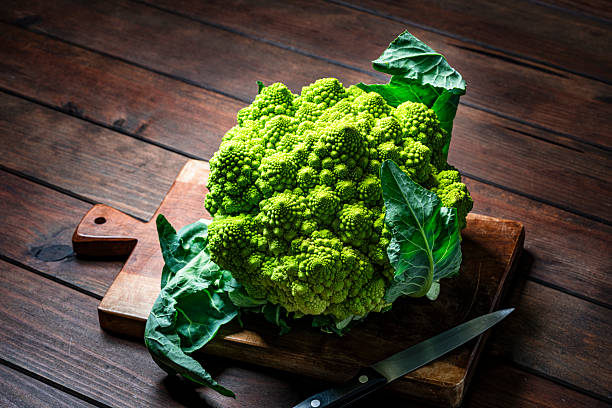 Organic Romanrsco cauliflower on cutting board. Gren vegetable for a healthy diet