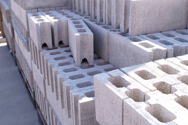 Blocks are being placed to form walls of structure in peaceful, outdoor construction site