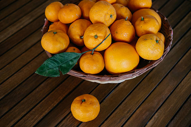 Orange clementine fruits in a bowl horizontal composition with a copy space.