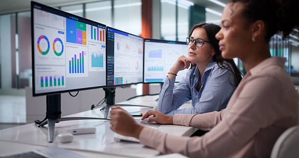 Diverse Women On Analytics Team Analyzing Financial Data stock photo