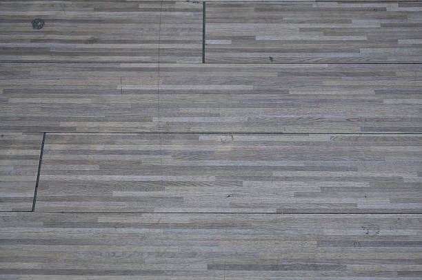 The wood-patterned floor is dirty and untidy