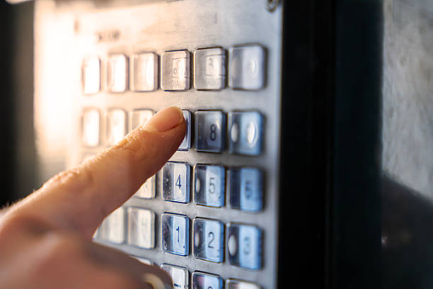 Extreme close-up of a worker’s finger pressing a button on a CNC machine control panel. Industrial automation, precision technology and manufacturing detail concept.