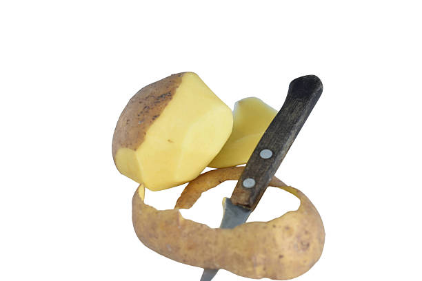 Not completely peeled potato and knife isolated on white background.