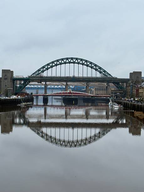 The famous Tyne bridges - Tyne Bridge, Swing Bridge and High Level Bridge -  the quayside of Newcastle on the right and Gateshead to the left, reflected in the River Tyne below