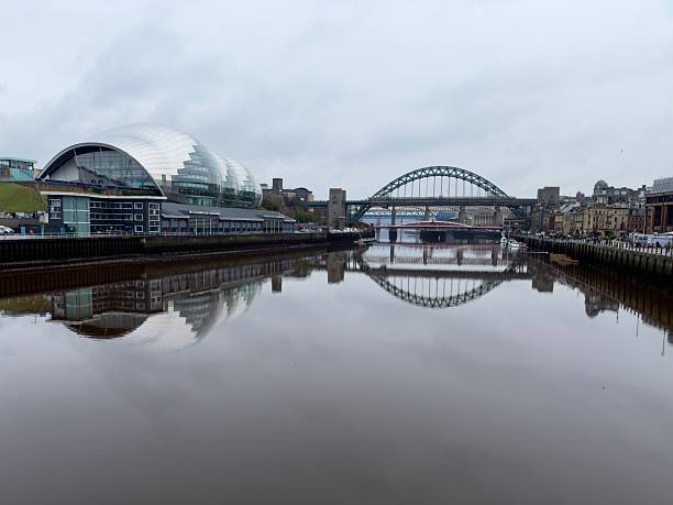 The famous Tyne bridges - Tyne Bridge, Swing Bridge and High Level Bridge -  the quayside of Newcastle on the right and Gateshead to the left, reflected in the River Tyne below