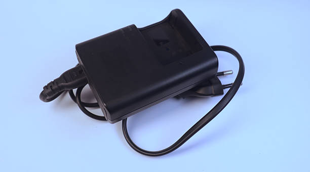 Charger and rechargeable lithium battery for camera isolated on clean background.