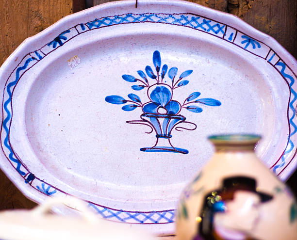a white round plate with floral and line pattern on white background