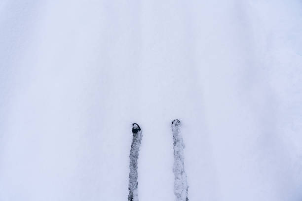 Backcountry splitboarder climbs mountain ridge, British Columbia