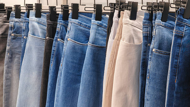 istock Denim jeans trousers hanging in a store 2260950597