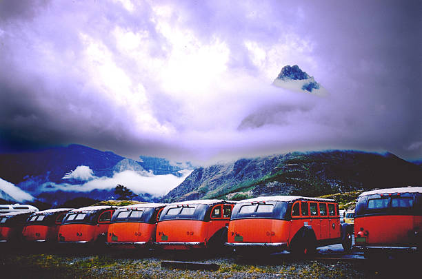 Glacier National Park, Montana - United States - September 13, 2007: Red Jammers vintage buses with sky