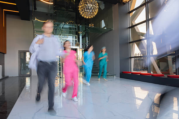 a long hospital corridor with green walls and white doors and lamps on the ceiling. interior of a medical institution.