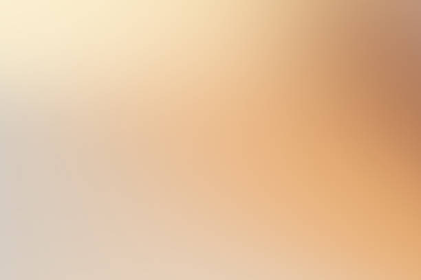 istock Abstract background blending soft warm beige, gold, and orange, creating a smooth glow 2260971595