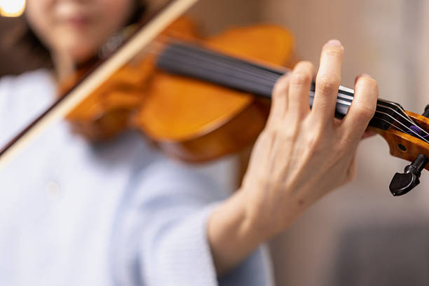 Close-up of woman’s hand playing the violin