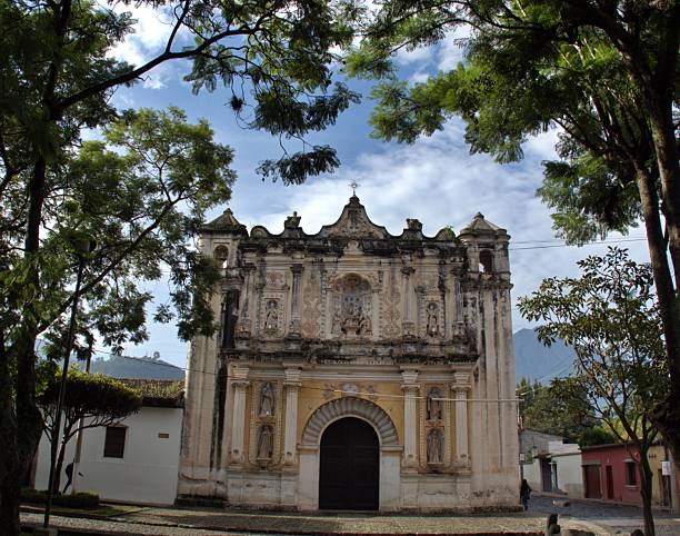 Old colonial church in Antigua surrounded by trees