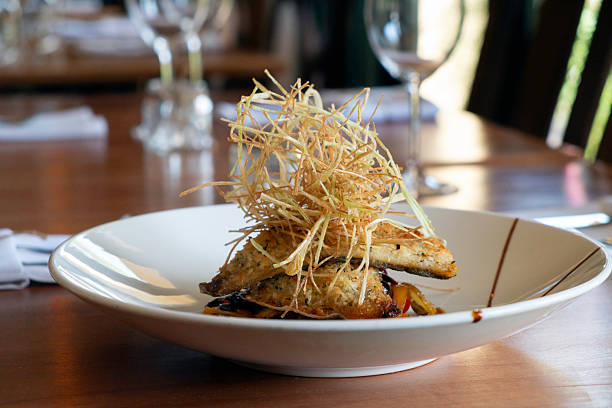 Halibut and Leek with spring onion and coriander served in dish isolated on wooden table side view of italian fastfood