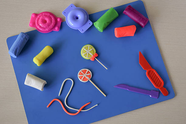 A beautiful and creative mess filled with an array of colorful play dough figures is scattered across a bright surface