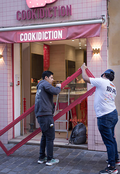 Paris, France - October 30, 2025: Construction workers outside a cookie shop just off rue des Rosiers in the Marais.